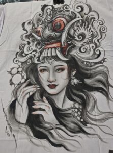 Rangda is a demon queen or witch queen in Balinese mythology. She is depicted as a terrifying figure, with long flowing hair, bulging eyes, large fangs, and long nails. Rangda leads an army of demons or evil witches, and is the arch enemy of Barong, who symbolizes goodness.